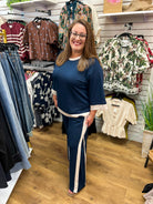 Navy blue wide leg pants set with cream colorblock trim, worn by model