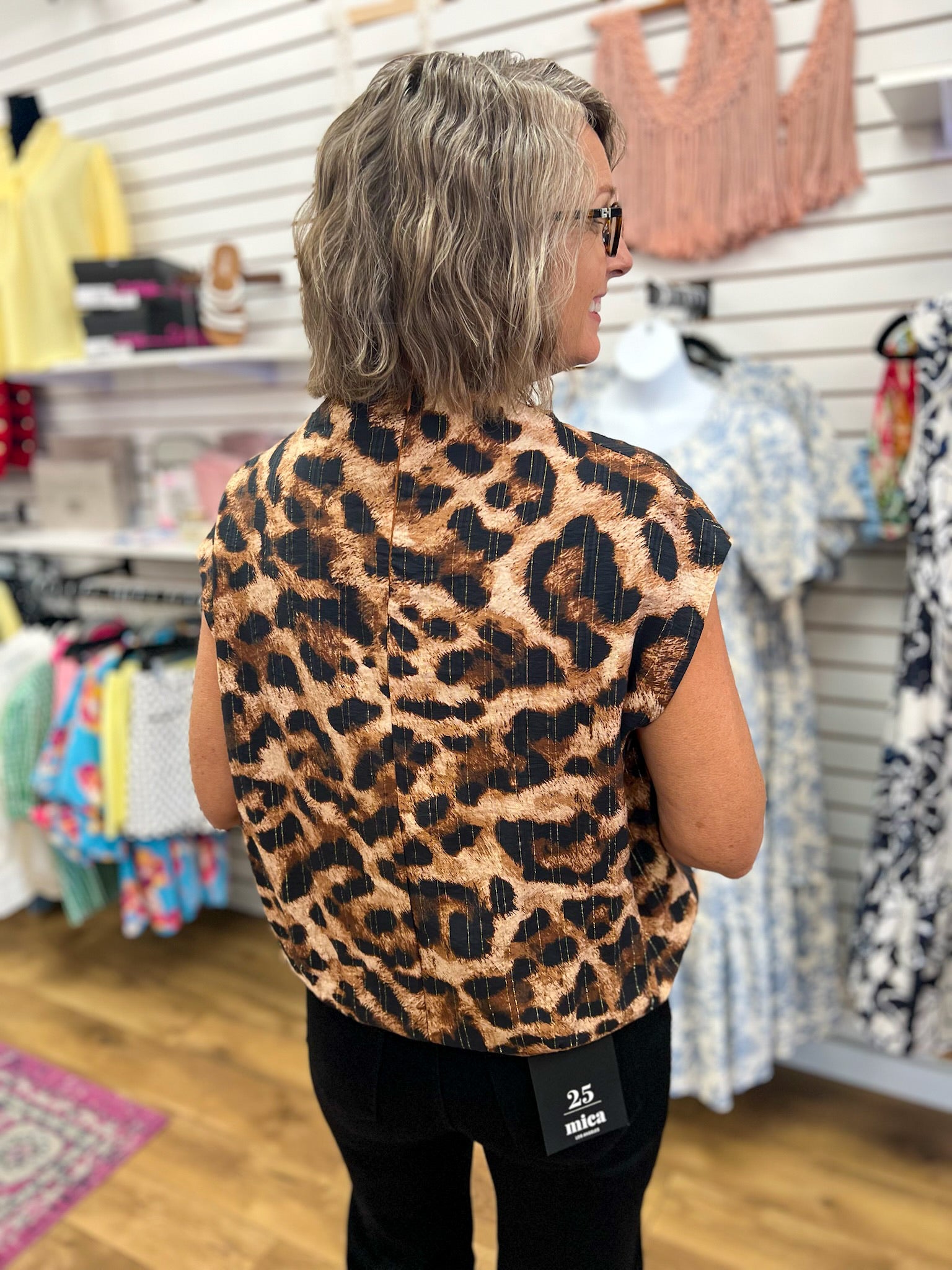 Brown leopard print sleeveless mock neck top shown from the back on model
