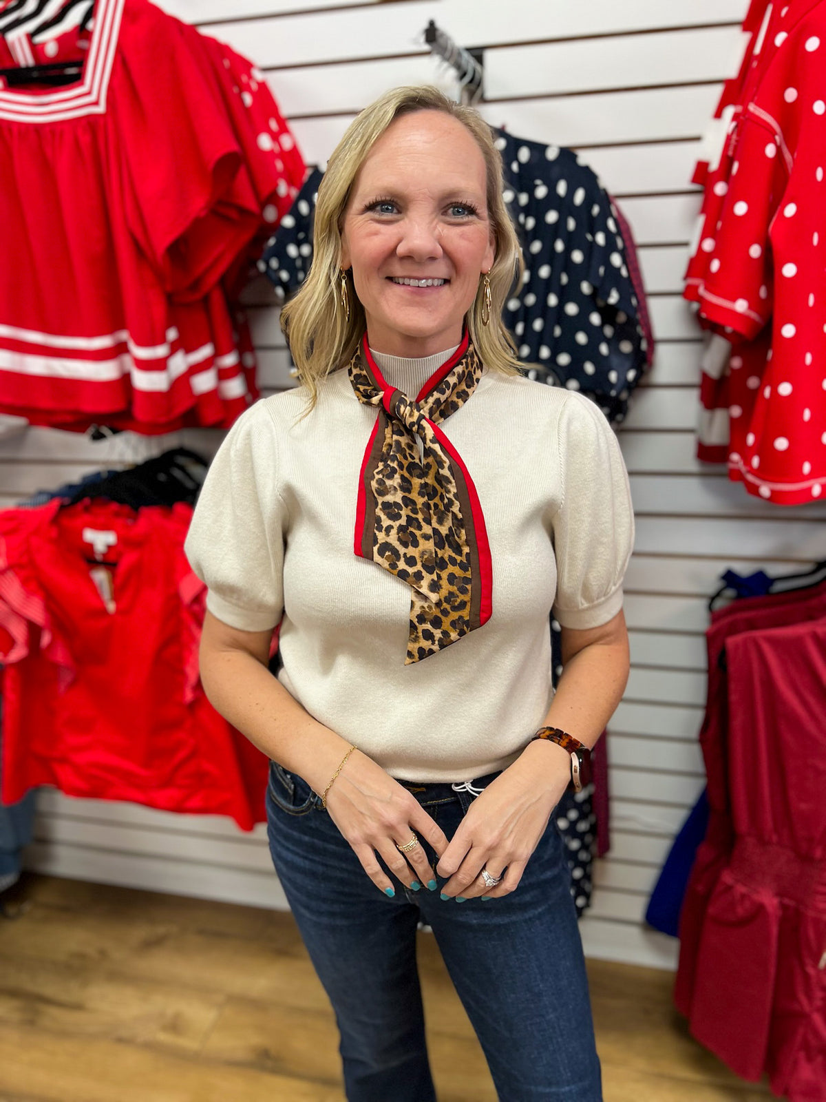 Ecru puff sleeve knit top styled with detachable leopard print red-trimmed neck scarf