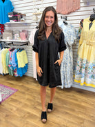 Black jacquard tonal V-neck dress with elbow length sleeves and side pockets