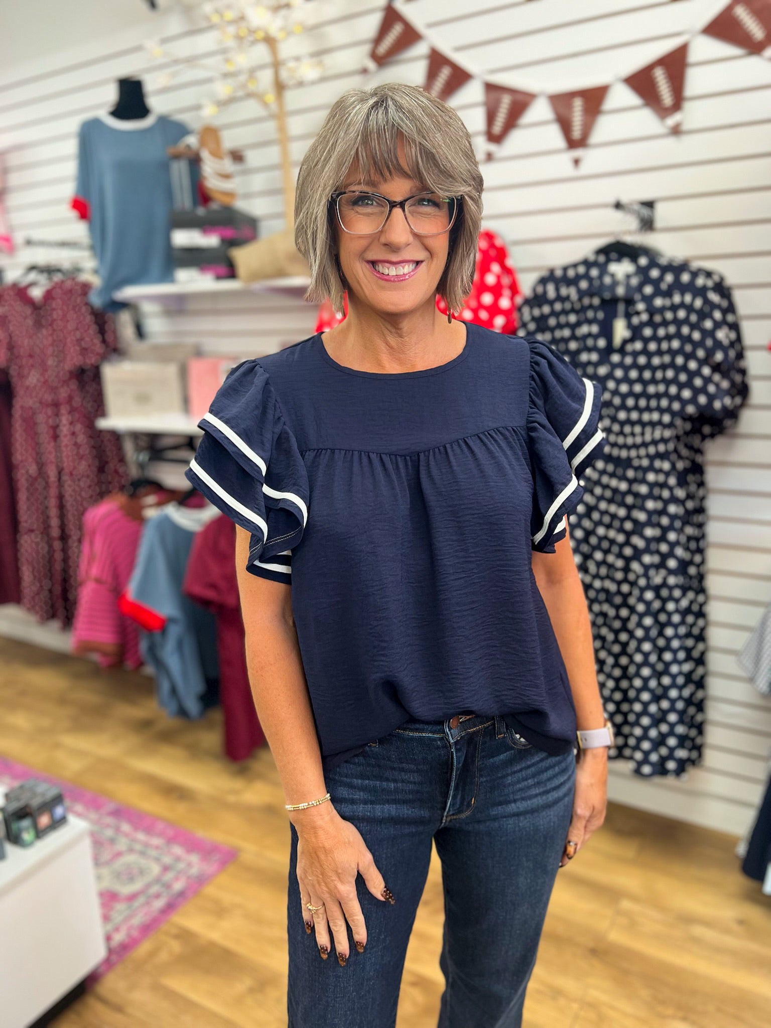 Navy blue ruffle flutter sleeve top with white contrast stripe piping detail