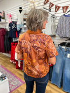 Entro brown tiger print short sleeve button-up top, back view, modeled with jeans