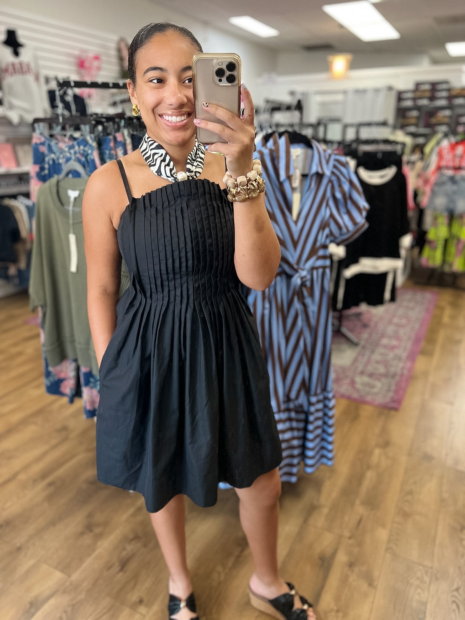 Black pleated bodice mini dress with adjustable spaghetti straps by Entro