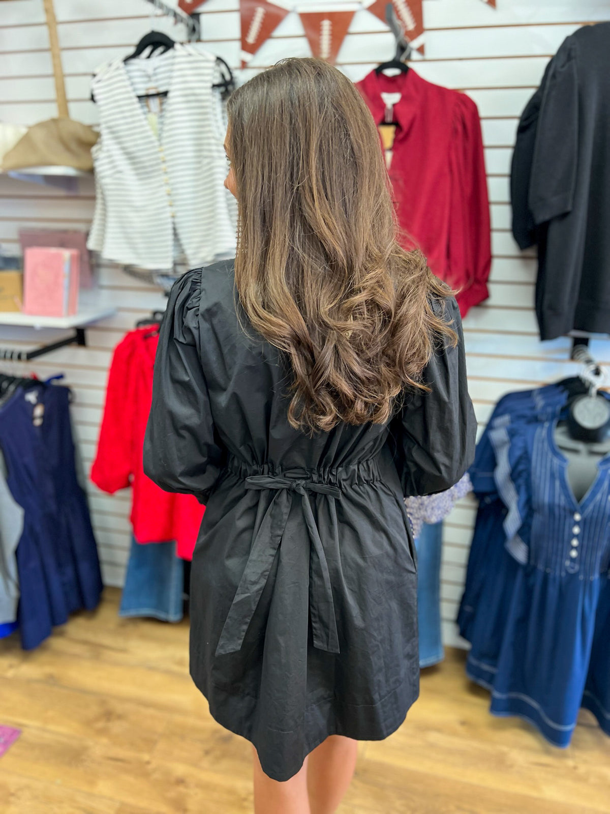 Black 3/4 sleeve mini dress with cinched waist bow tie and ruffle details