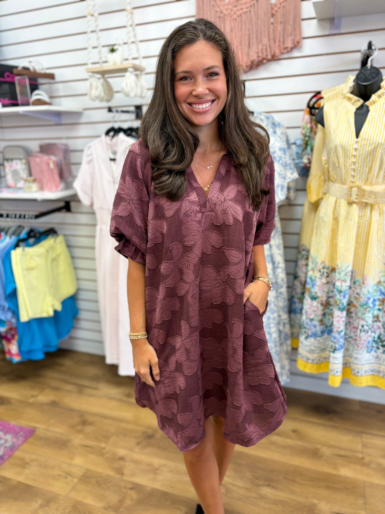 Maroon tonal floral jacquard mini dress with v-neck, elbow sleeves, and side pockets