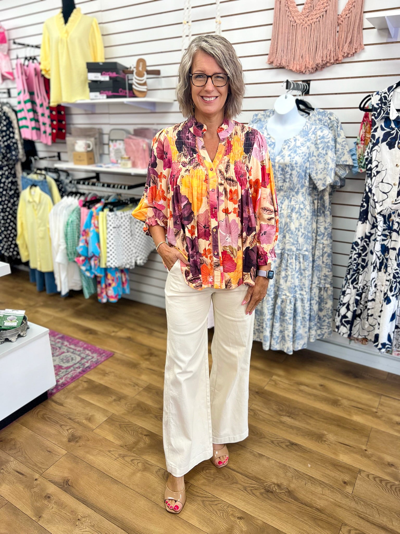 Umgee ecru floral V-neck button-up top with smocking detail, worn with white wide-leg pants