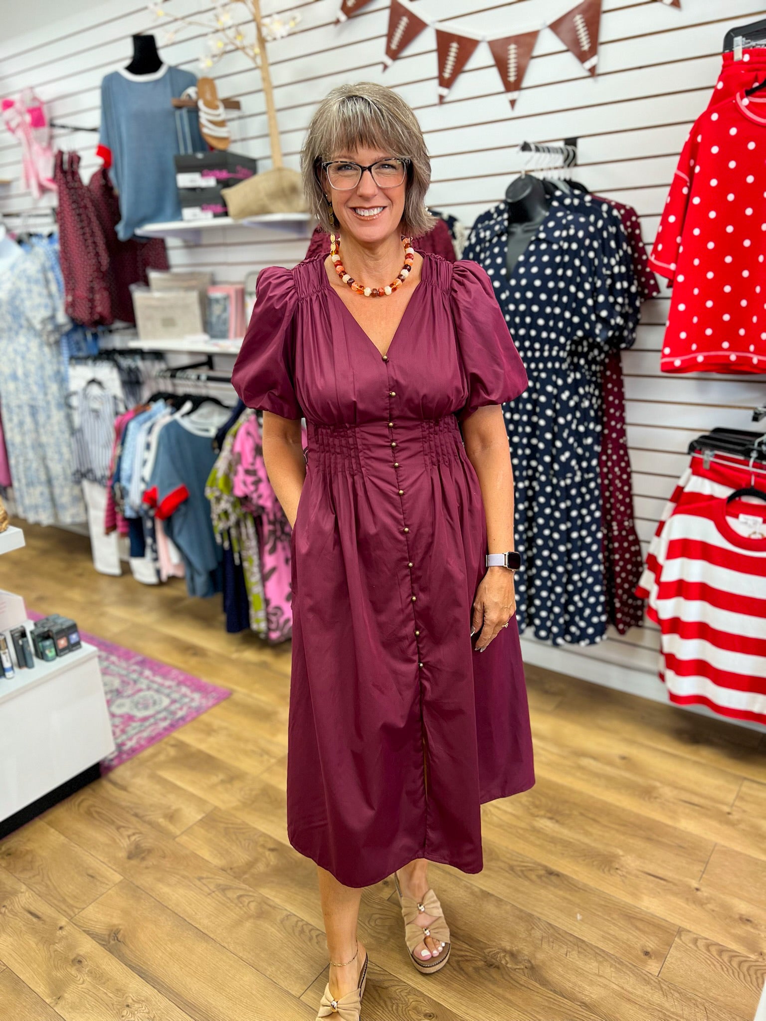 Wine burgundy midi dress with puff sleeves, gold buttons, smocked waist, and pockets