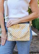 Caroline Hill metallic champagne quilted crossbody bag with gold chain and logo clasp