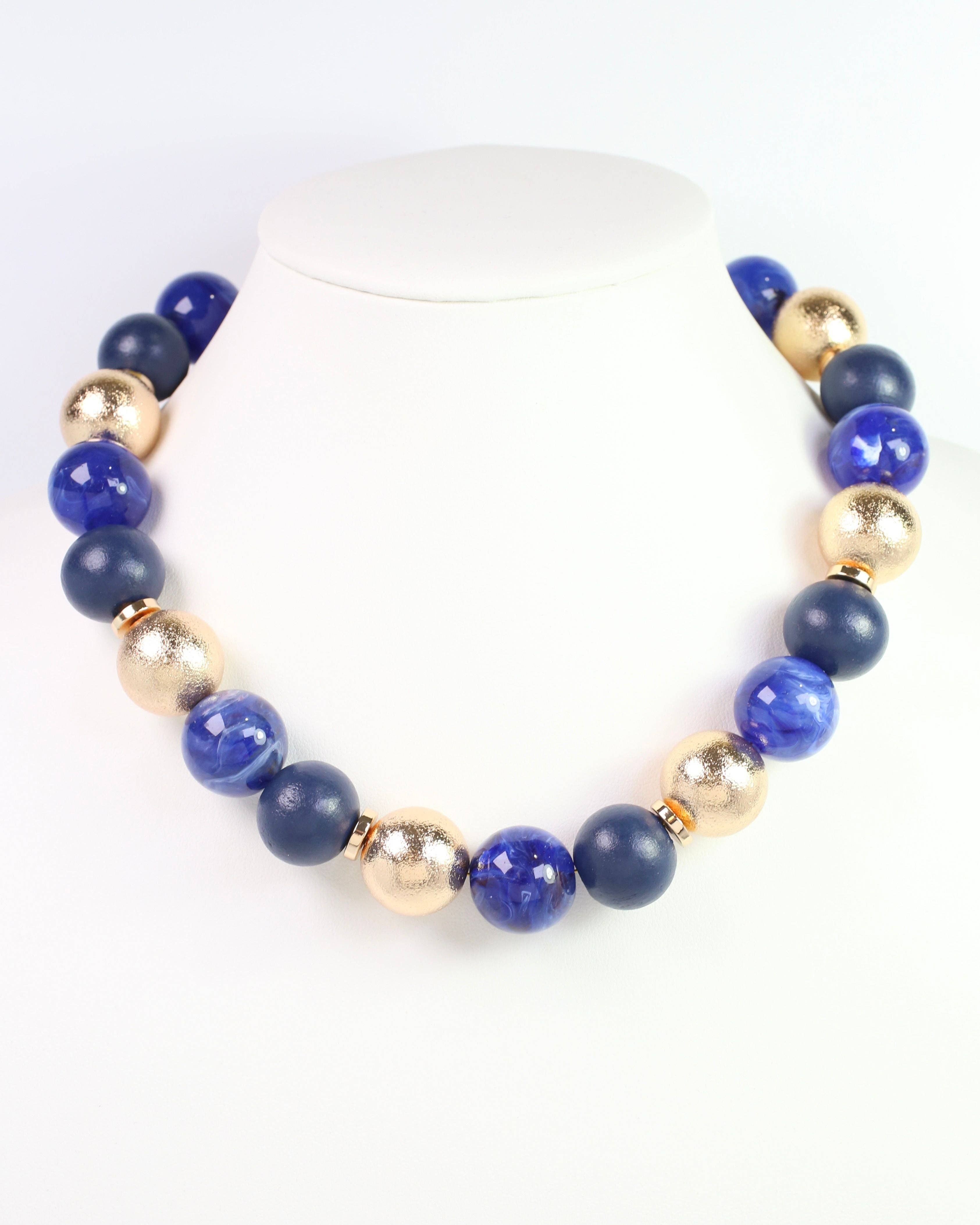 Caroline Hill Elaine navy blue and gold beaded ball statement necklace on display bust