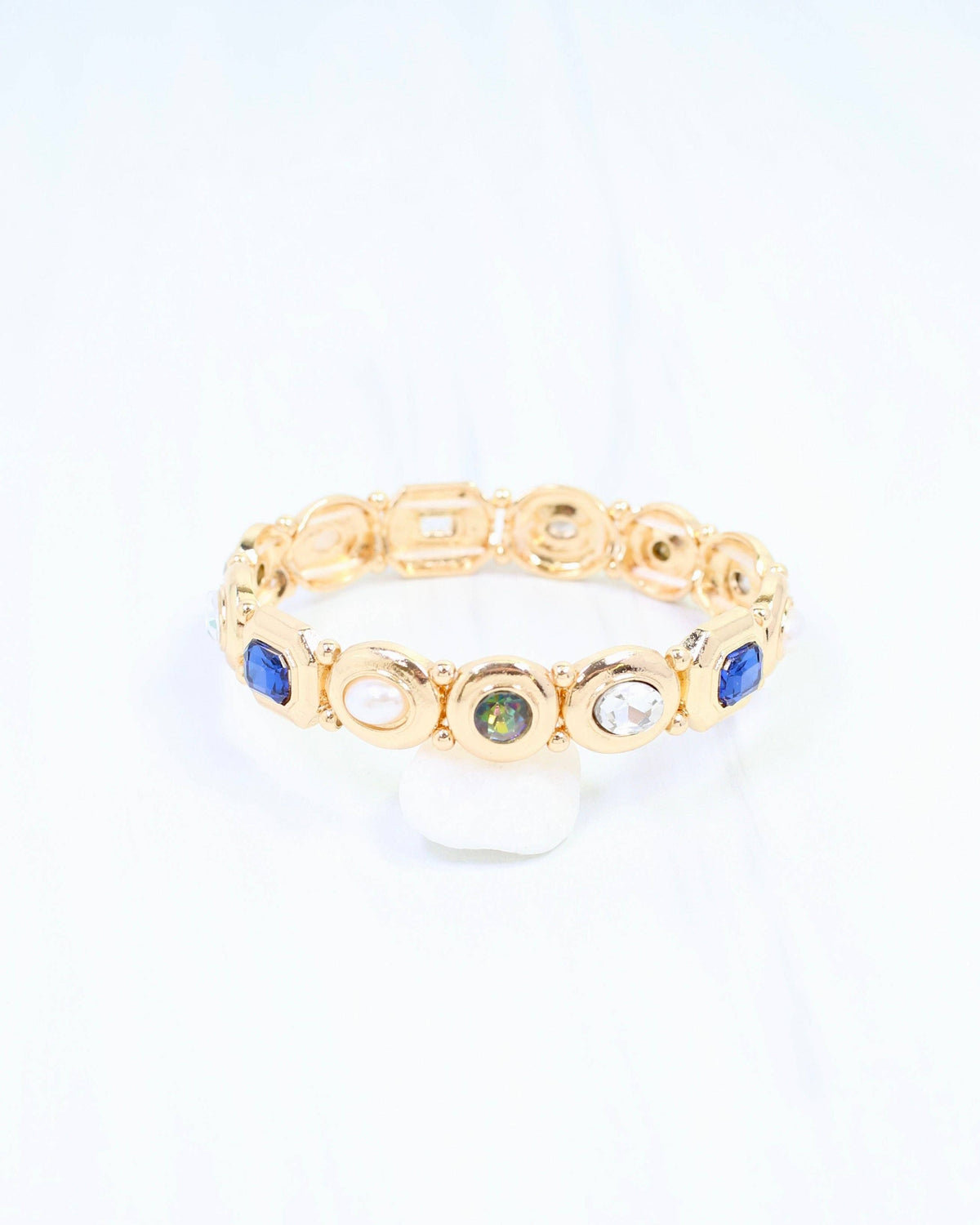 Gold stretch bracelet with blue, pearl, opal, and crystal gemstones