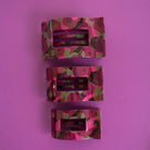 Three pink camouflage flat rectangle hair clips in graduating sizes on purple background